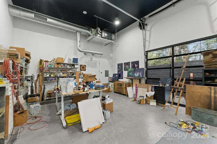 Studio / workshop features amazing large glass hanger door.