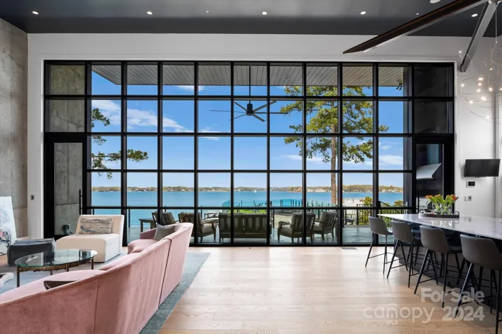 Expansive glass facade in the open concept upper level with endless lake views.