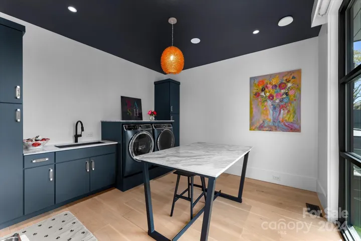 The expansive laundry room features a generous folding counter, combining functionality with elegance.