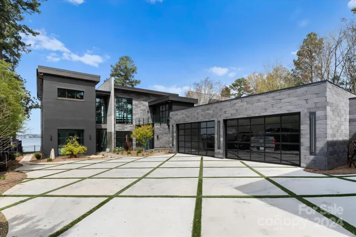 The 4 car garage feautures custom glass garage doors.