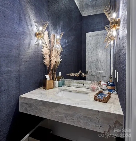 Powder room with floating quartzite sink, grasscloth wallpaper and Toto Toilet.