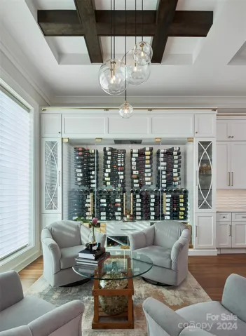 Temperature controlled wine wall with storage for large format & collector cases, as well as humidor drawer.  Side cabinets house glassware on top, and pullout storage for spirits or entertaining items.