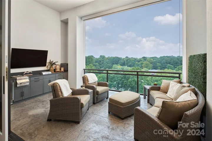 Lanai overlooking resort pool features automated sunshades & built ins with electric grille, under counter stainless beverage, and storage.