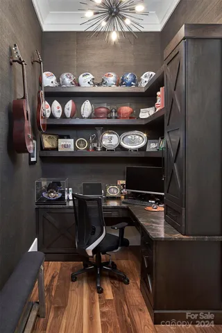 Custom office features open and closed shelving, leathered quartzite counters and grasscloth wallpaper.