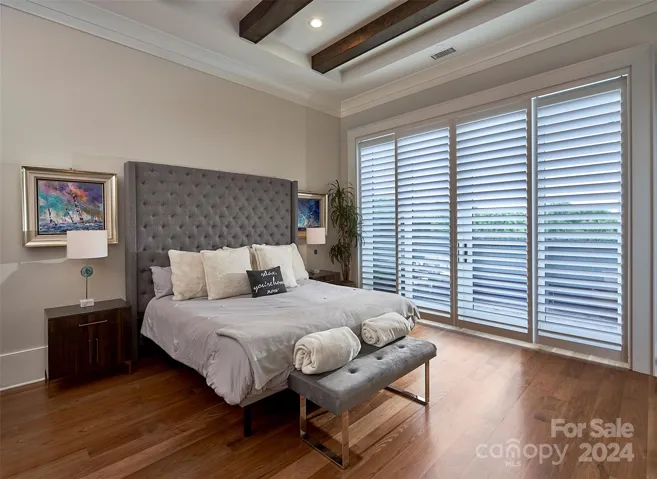 Custom wood shutters open to private balcony.