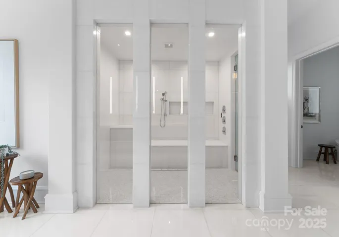 Primary steam shower and primary bathroom with marble heated tile floors