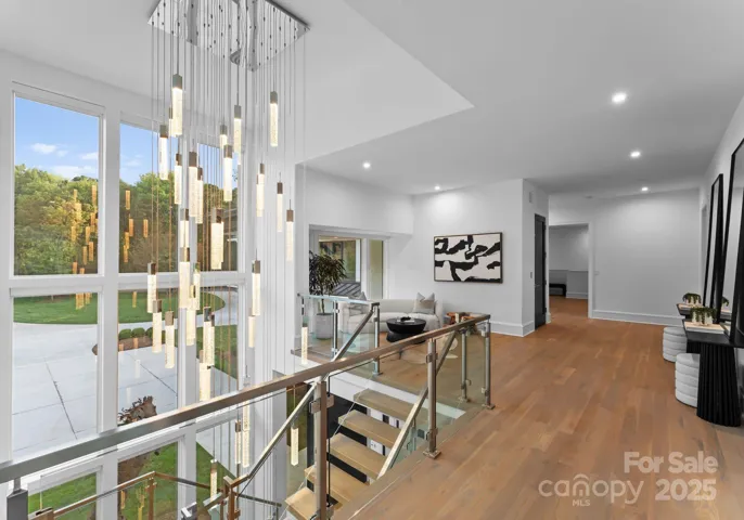 Upper level with 49 hanging pendant light that cascades to all three levels of the home