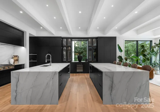 Double kitchen islands with waterfall quartzite