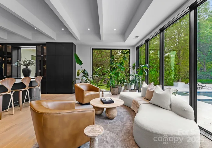 Sitting area off kitchen overlooking expansive pool deck area