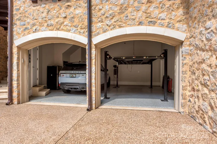 Two of the three garage bays include hydraulic car lifts.  Room for 5 vehicles inside and several more outside.