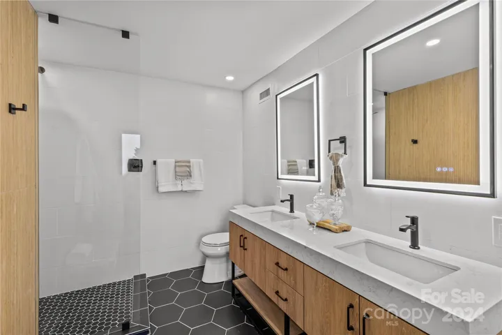 Oooolala! Primary bath is a stunner! with full tile surround and modern yet warm design!