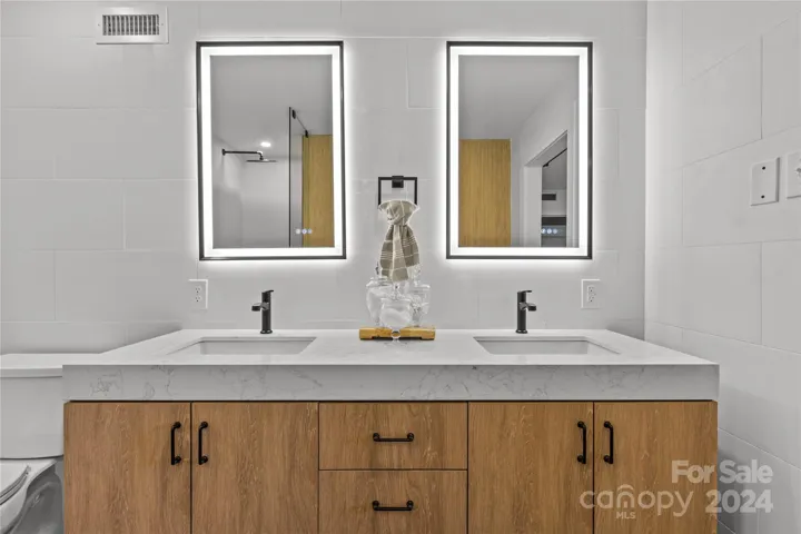 Double white oak vanity with floating backlit mirrors
