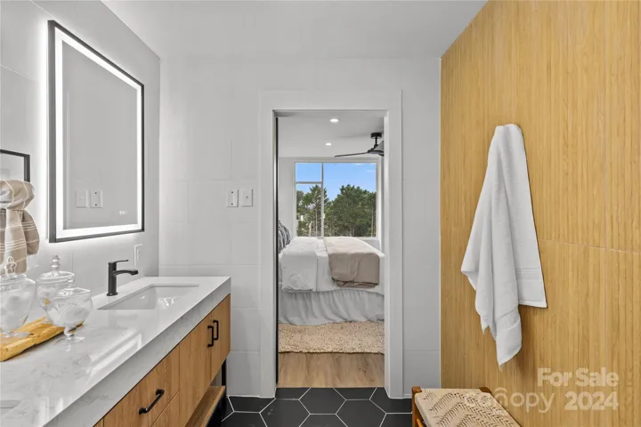 Beautiful accent wall ties in with the vanity