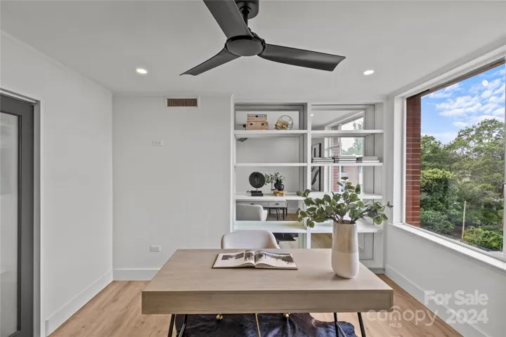 Note custom built-in shelves, and large window