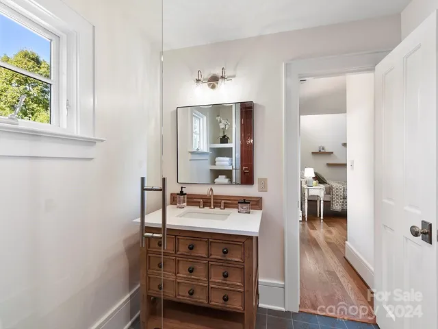 View from inside shower to updated bath vanity in one of the ensuites.
