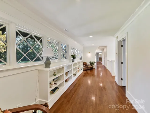 Beautiful main hallway upstairs with plenty of knocks to get lost in and read a book or relax.