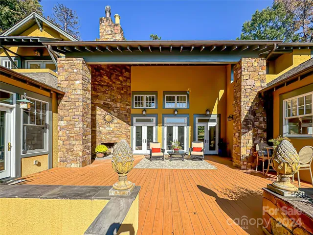 Rear view of covered porch area for autumn nights with a fire.