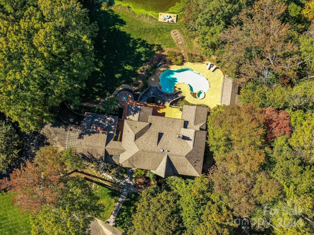 Drone view of 524 Shoreline Dr with two lots and 3rd lot across the street for septic area. 6.40 acres total. Survey not found but community polt map attached in attachments.