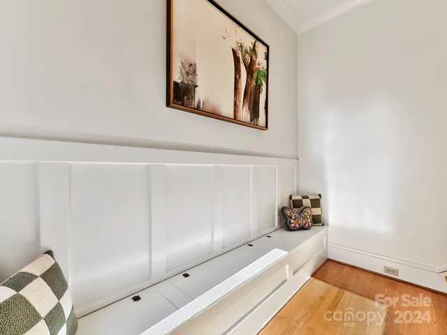Upstairs landing with built in storage and refinished hardwood floors