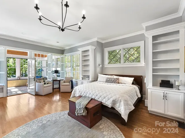 Primary bedroom with fireplace, sunroom and private remodeled bath with large walk-in shower, dual vanities, separate laundry area - large laundry upstairs as well