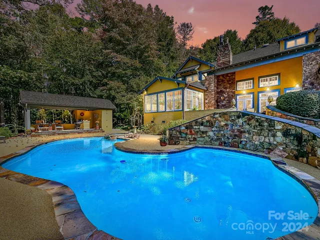 Private pool with spill over hot tub, covered bar area, pool half bath, sauna and access to the lake.