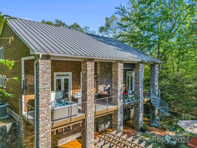 Back of home - hot tub on main level deck