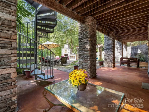 Stained concrete patio w/spiral staircase to main level deck