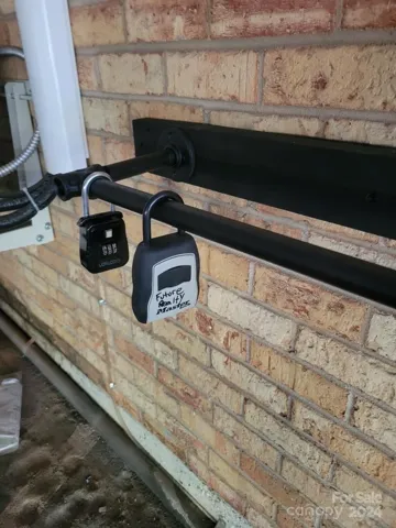 Lockbox Location photo- under parking garage; on black railing marked w/owner's name "Future Realty"
