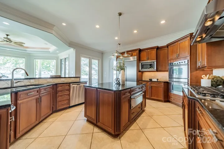Kitchen with island, gas stove, and stainless appliances