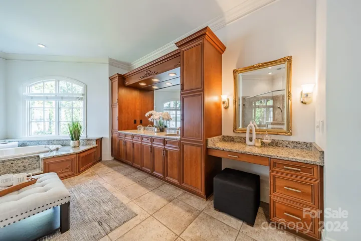 Primary bathroom with vanity, and ample counter space around 2 sinks