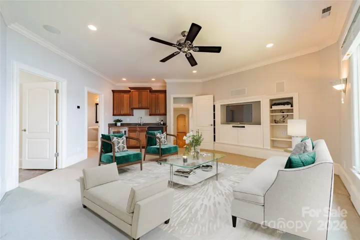 Upstairs media room with wet bar, fridge and microwave (virtually staged)
