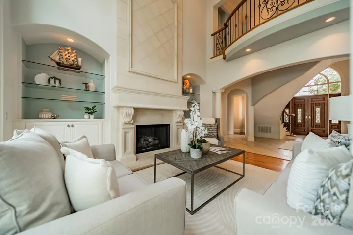 Intimate living room boasts 20' cathedral ceilings and built ins around fireplace.