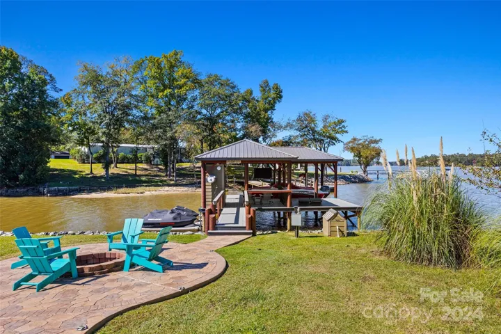 Fire pit and dock with boat lift and jet ski ramps.