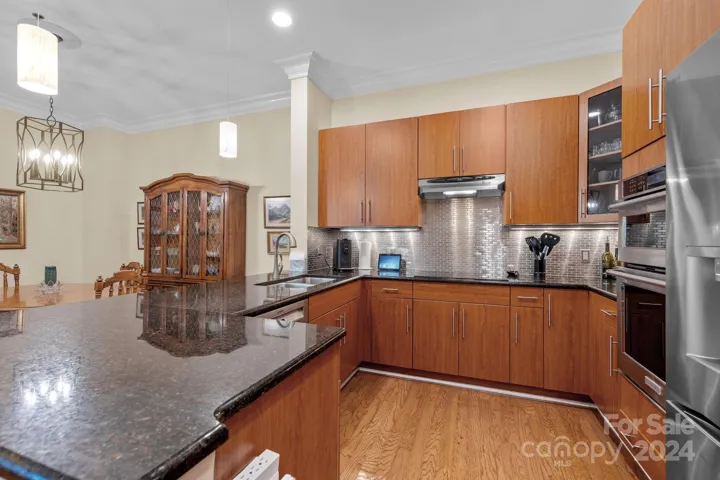 Kitchen features an induction cooktop, wall oven, microwave, French door fridge, dishwasher. All appliances convey.