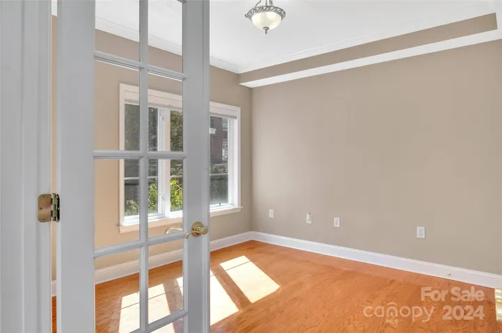 Bedroom 3/office just beyond a set of French doors.