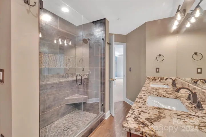 Fully tiled tub with corner seat and vanity granite countertops just a few of the luxuries in this unit.