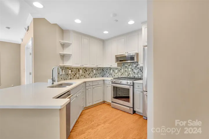 Central kitchen with SS appliances, a pantry and lots of storage.