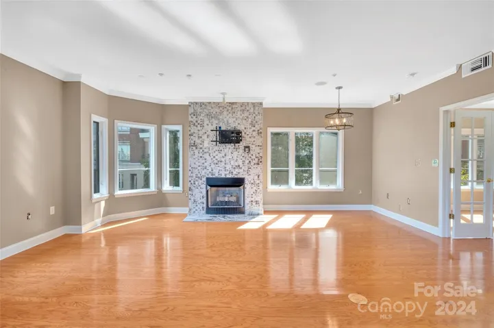 Beautiful gas log fireplace in the living room.  Natural light filled living area.
