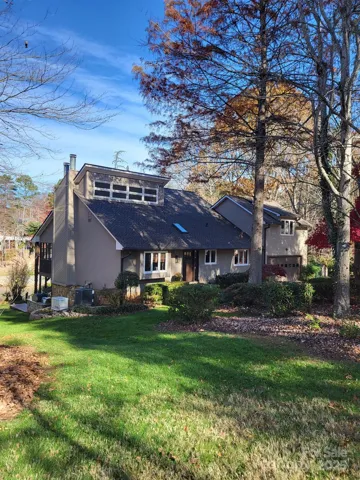 Custom-built home with mature yard with Japanese maples, huge Magnolia tree, and a greenhouse for the gardening lovers.