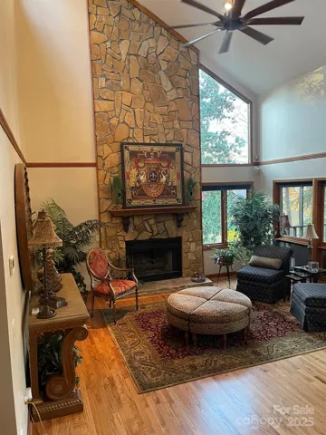 Enter the home into the bright great room featuring high windows facing front and windows & access to screened-in-porch facing lakeside.