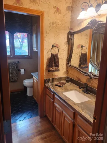 Main floor bath with 2 separate leathered granite vanities.