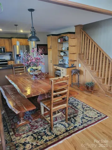 View of dining and stairwell up to primary ensuite.  Built-in desk area.