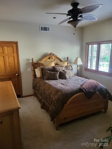 Basement bedroom with views of lake and big walk-in closet and attached bathroom! Can be used as a 2nd primary if needed!