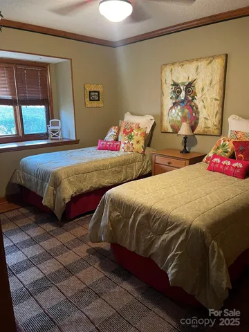 Main floor bedroom w/walk-in closet and ceiling fan.