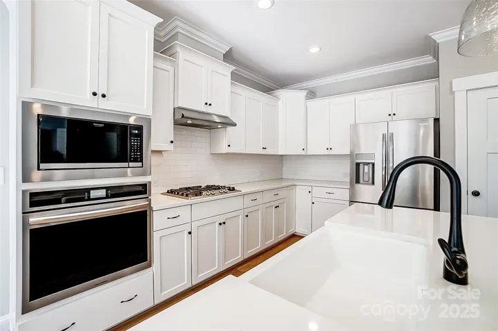 Engage your inner chef in the gourmet kitchen boasting gas cooktop, huge island, ss appliances, and tons of counter space