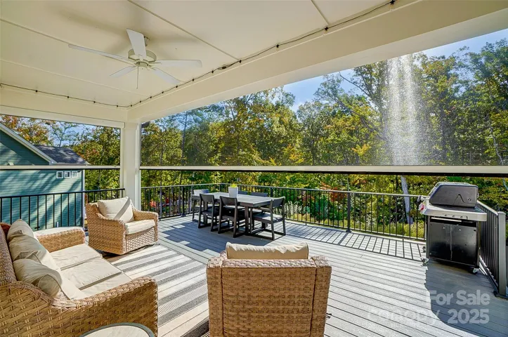 Covered deck with electric remote screen is perfect for entertaining