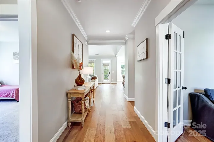 Bright and open floorplan, beautiful flooring, rich molding, and custom finishes