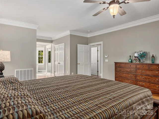 Master suite walk in  closets separate the bedroom from bath