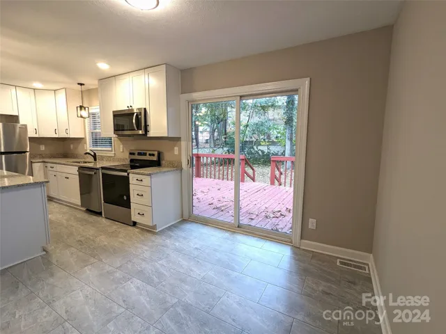 Dining room looks out over deck and backyard.