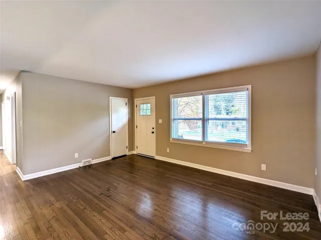 Living room has view out to wooded neighborhood.